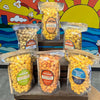 Assorted bags of popcorn with colorful labels against a vibrant mural background