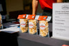 Signature Popcorn bags with branded cards on a corporate gifting display table